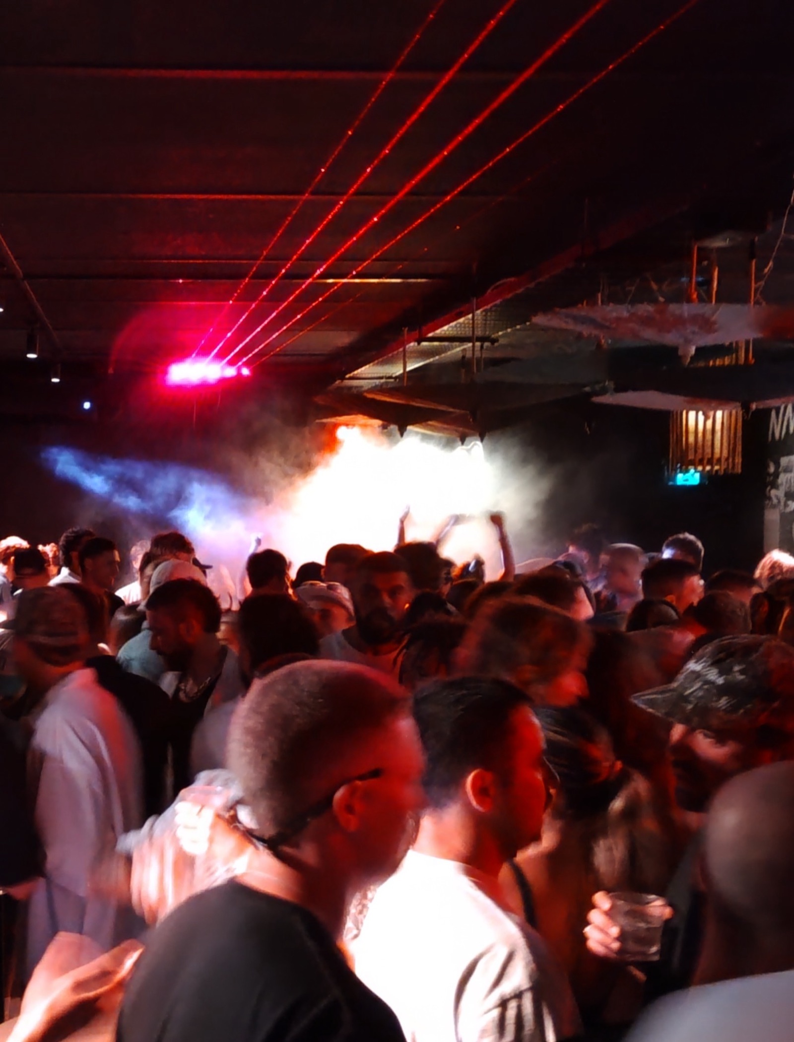 Packed crowd at Naami with lasers and smoke