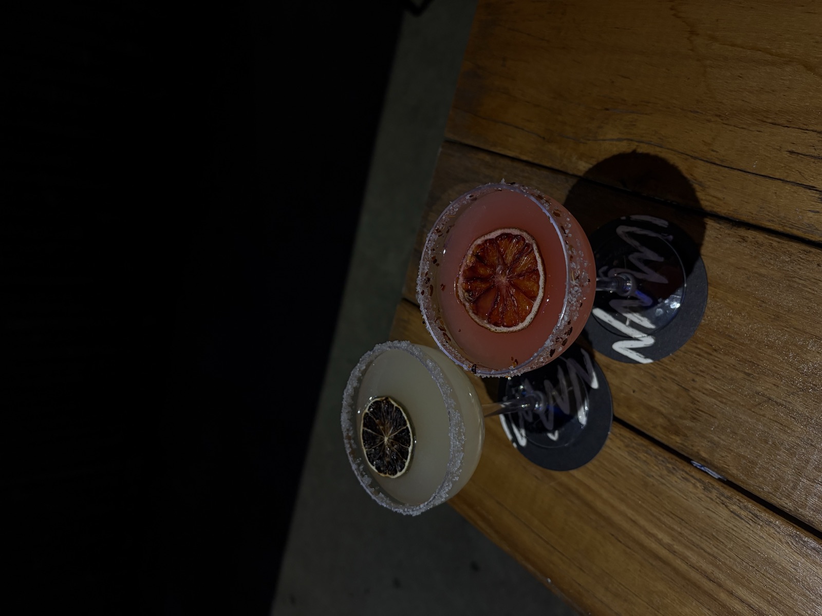 Naami signature cocktails on branded coasters